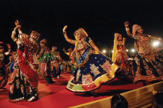 Localites performing Garba in traditionally dressed attire
