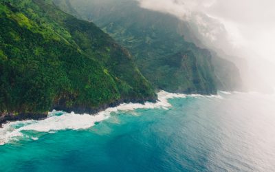 high-angle-shot-beautiful-foggy-cliffs-calm-blue-ocean-captured-kauai-hawaii