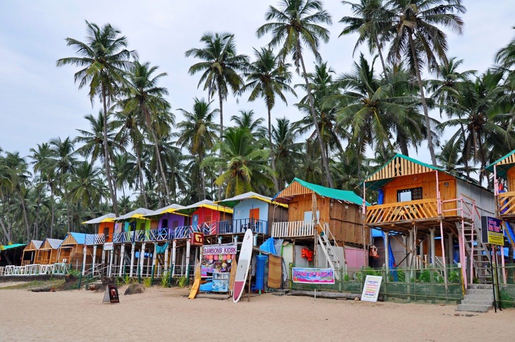 Goa beach-side shacks surrounded by palm trees