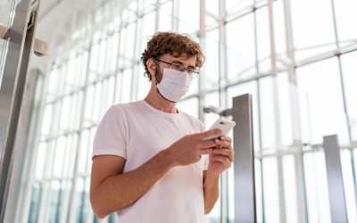 man-wearing-face-mask-airport-using-smartphone